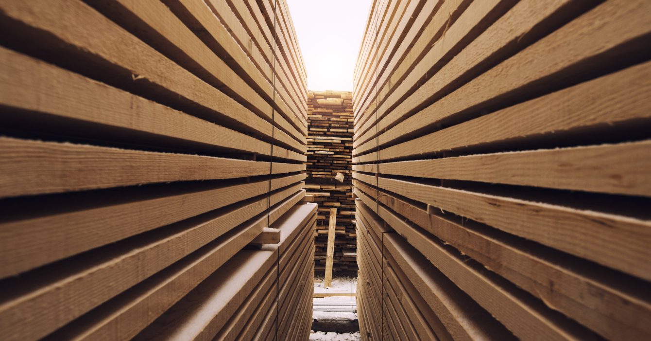 Stack of wooden planks in sawmill lumber yard.