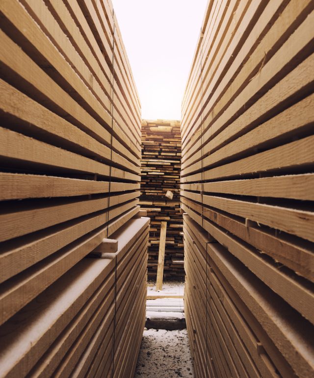 Stack of wooden planks in sawmill lumber yard.